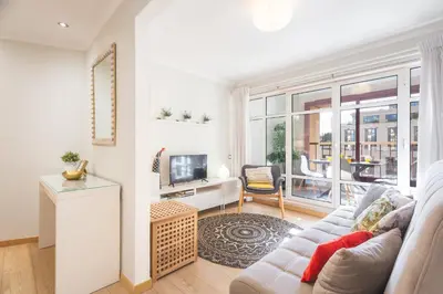 a living room with a couch and a tv at Tropical Sun by Atlantic Holiday in Funchal