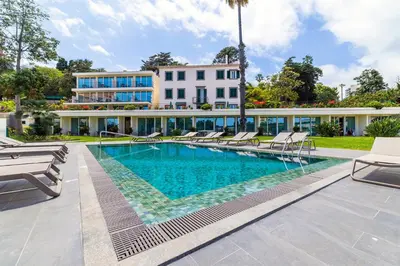 a swimming pool in front of a building at Pestana Quinta Perestrello in Funchal
