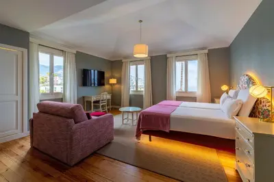a hotel room with a bed and a chair at Pestana Quinta Perestrello in Funchal