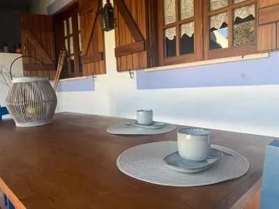 two cups and saucers sitting on a kitchen counter at Entre a Serra e o Mar - Casa das Rosas de Barão in Barão de São João