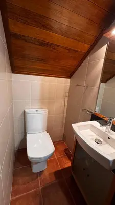 a bathroom with a toilet and a sink at Casa dos Lamaceiros in São Vicente