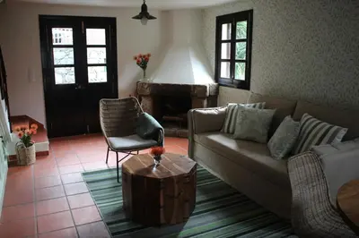 a living room with a couch and a chair at Casa dos Lamaceiros in São Vicente
