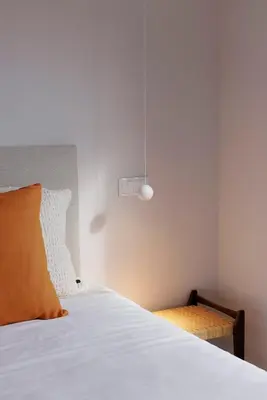 a bedroom with a bed with an orange pillow at Casa de Viriato in Funchal