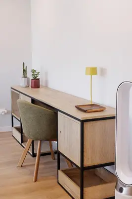 a wooden desk with a chair and a lamp at Casa de Viriato in Funchal