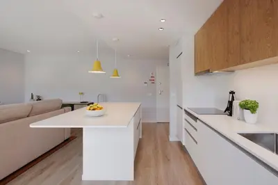 a kitchen with white counters and a white counter top at Casa de Viriato in Funchal
