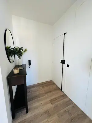a room with a table and a mirror and a door at Arrifana Sunrise & Mountain View in Aljezur