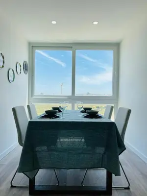 a dining room with a table with wine glasses at Arrifana Sunrise & Mountain View in Aljezur