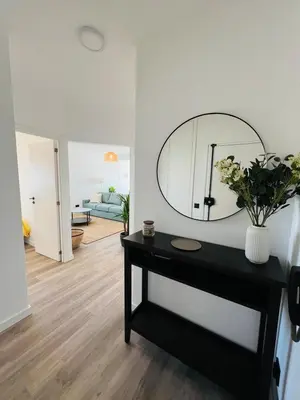 a living room with a mirror and a table at Arrifana Sunrise & Mountain View in Aljezur