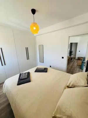 a bedroom with a large bed with two towels on it at Arrifana Sunrise & Mountain View in Aljezur