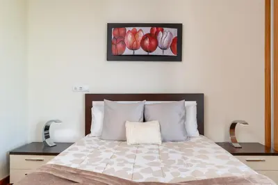 a bedroom with a bed with a picture of apples at Las Rosas Vista Baia do Funchal in Funchal