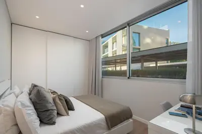a bedroom with a bed and a large window at Maravilhas I by An Island Apart in Funchal