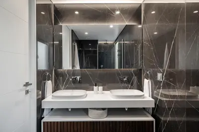 a bathroom with two sinks and a large mirror at Maravilhas I by An Island Apart in Funchal