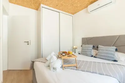 a bedroom with a bed with a table on it at Atlantic Lookout by Atlantic Holiday in Calheta
