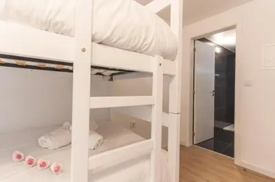 a white bunk bed in a room with a mirror at Atlantic Lookout by Atlantic Holiday in Calheta