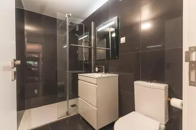 a bathroom with a toilet and a sink and a shower at Atlantic Lookout by Atlantic Holiday in Calheta