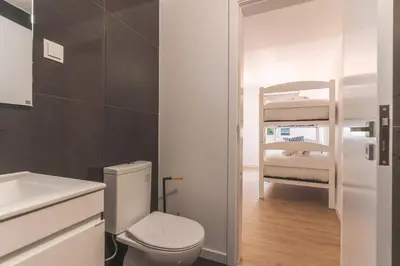 a bathroom with a toilet and a bunk bed at Atlantic Lookout by Atlantic Holiday in Calheta