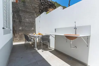 a kitchen and dining area with a table and chairs at Atlantic Lookout by Atlantic Holiday in Calheta