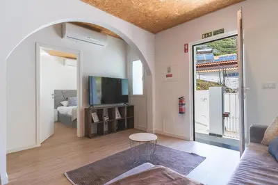 a living room with a couch and a tv at Atlantic Lookout by Atlantic Holiday in Calheta