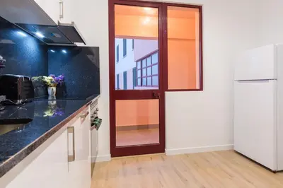 a kitchen with a glass door and a counter top at GuestReady - Charming home in Câmara de Lobos in Câmara de Lobos
