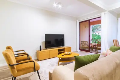 a living room with a couch and a tv at GuestReady - Charming home in Câmara de Lobos in Câmara de Lobos