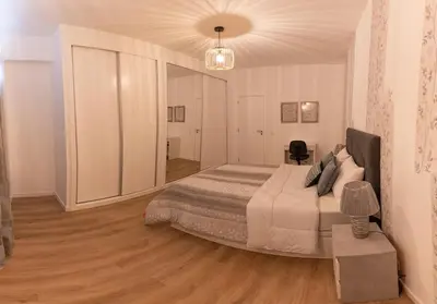 a bedroom with a large bed in a room at Sol do Lido, esplendor do Funchal in Funchal