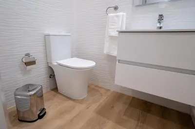 a bathroom with a toilet and a sink at Sol do Lido, esplendor do Funchal in Funchal