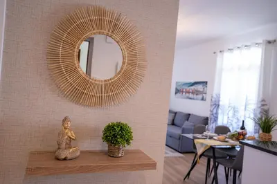a living room with a mirror and a table at Sol do Lido, esplendor do Funchal in Funchal