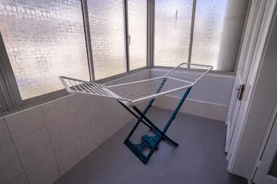 a shopping cart in a bathroom with windows at Sol do Lido, esplendor do Funchal in Funchal