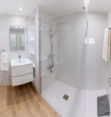 a white bathroom with a shower and a sink at Sol do Lido, esplendor do Funchal in Funchal