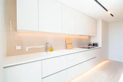 a white kitchen with white cabinets and a sink at Savoy Monumentalis your home in Madeira Island in Funchal