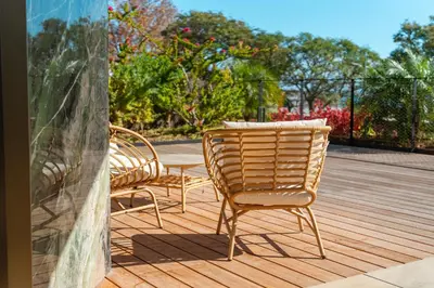 two chairs and a table on a wooden deck at Savoy Monumentalis your home in Madeira Island in Funchal