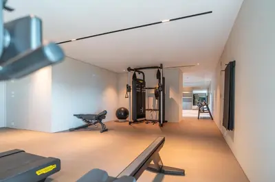 a room with a gym with a bench and equipment at Savoy Monumentalis your home in Madeira Island in Funchal