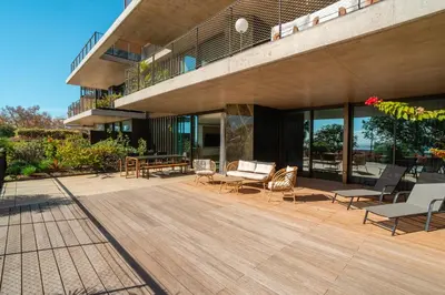 a building with a deck with chairs and tables at Savoy Monumentalis your home in Madeira Island in Funchal