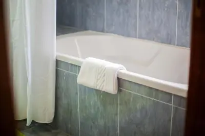 a bath tub in a bathroom with a towel on it at Casa Terra da Vinha in Canhas