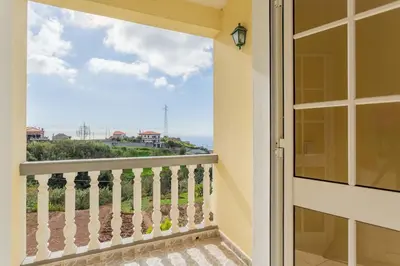 a balcony with a view of the ocean at Casa Terra da Vinha in Canhas