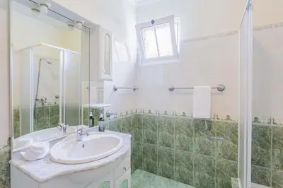 a bathroom with a sink and a shower at Casa Terra da Vinha in Canhas