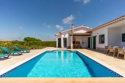 a swimming pool in front of a villa at Sunny Ocean Villa with pool near Arrifana beach in Aljezur
