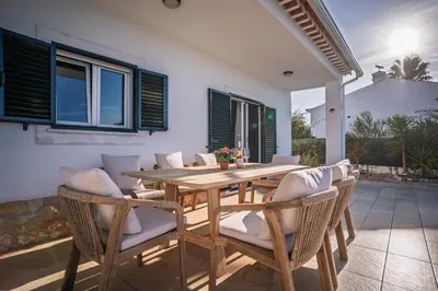 a dining room with a wooden table and chairs at Sunny Ocean Villa with pool near Arrifana beach in Aljezur