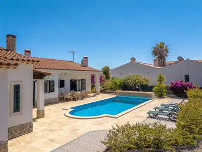 a backyard with a swimming pool and a house at Sunny Ocean Villa with pool near Arrifana beach in Aljezur