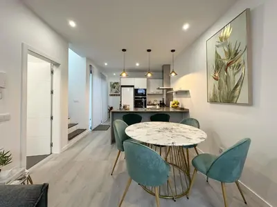 a dining room and kitchen with a table and chairs at City Center House in Funchal