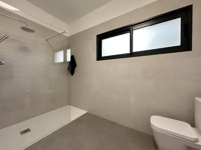 a bathroom with a toilet and a window at City Center House in Funchal