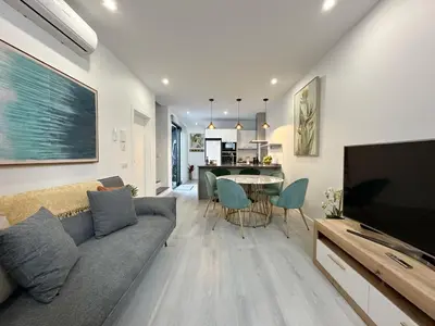 a living room with a couch and a tv and a table at City Center House in Funchal