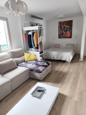 a living room with a couch and a bed at Benedict Funchal Center in Funchal