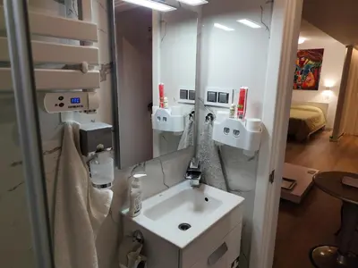 a bathroom with a sink and a mirror at Benedict Funchal Center in Funchal