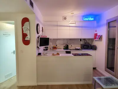 a kitchen with white cabinets and a counter top at Benedict Funchal Center in Funchal