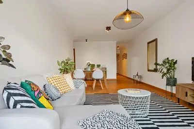 a living room with a couch and a table at Refúgio Girassol in Caniço