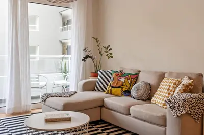 a living room with a couch and a table at Refúgio Girassol in Caniço