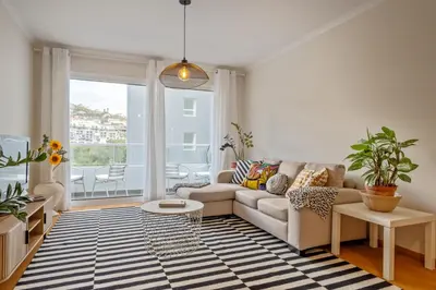a living room with a couch and a table at Refúgio Girassol in Caniço