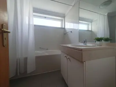 a bathroom with a sink and a tub and a shower at Aqua Vista Lido Apartment in Funchal