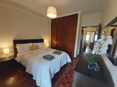 a bedroom with a bed and a vase of flowers at Jose's Place Holiday Apartment in Funchal